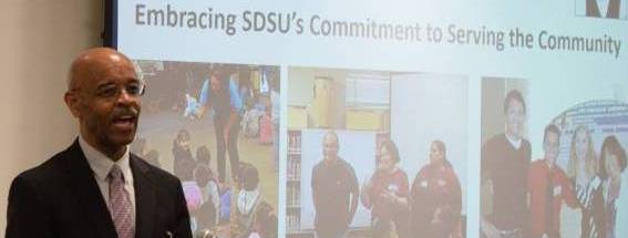 Provost Joseph Johnson in front of slide from award ceremony